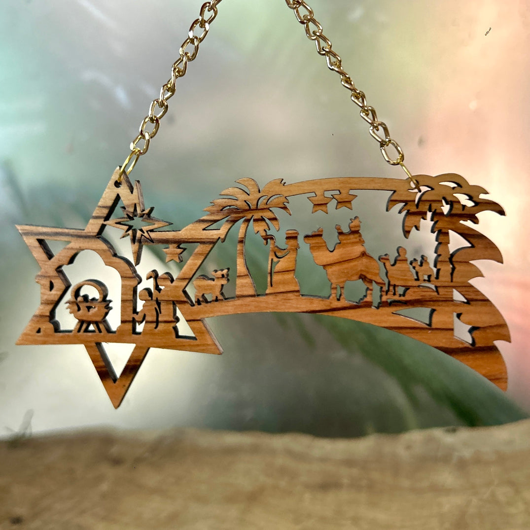 Wooden nativity scene hanging ornament with a star of David design.