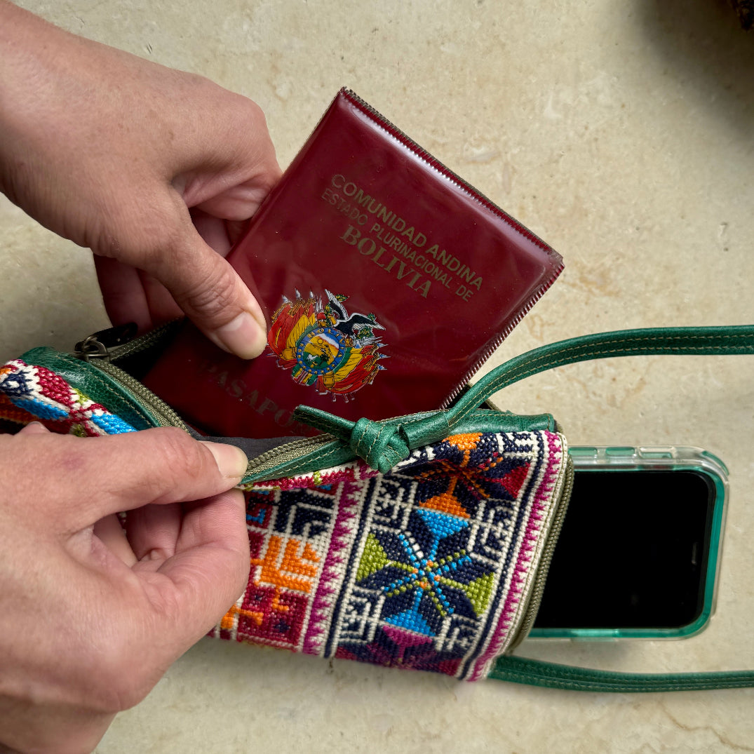 Colorful embroidered pouch with a phone case and a passport being taken out.