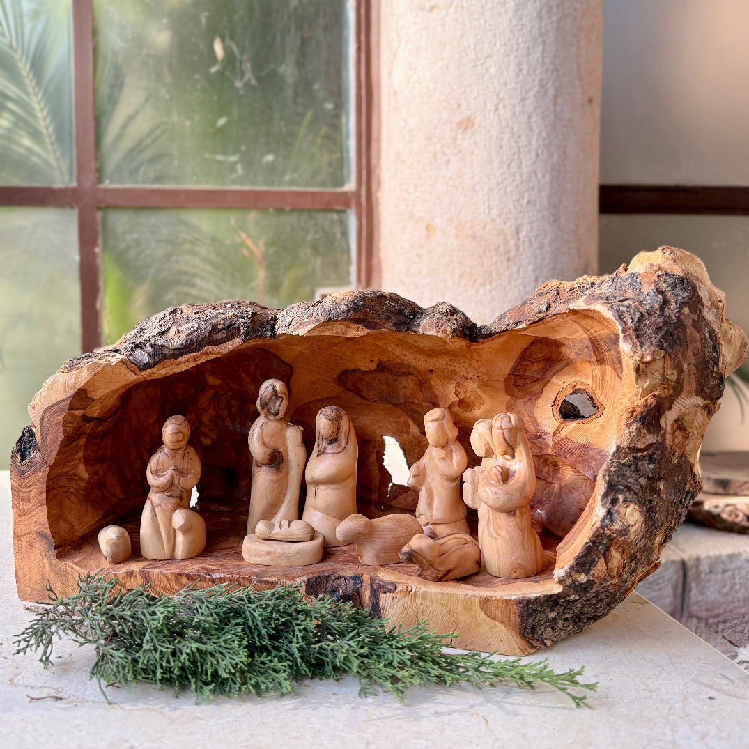 Wooden nativity scene in a rustic setting with natural light